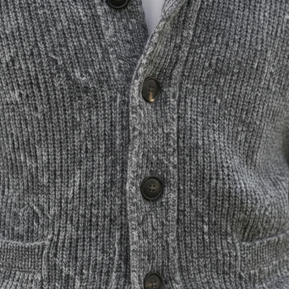 A man wearing a grey shawl-collar cardigan showing a refined and casual style.