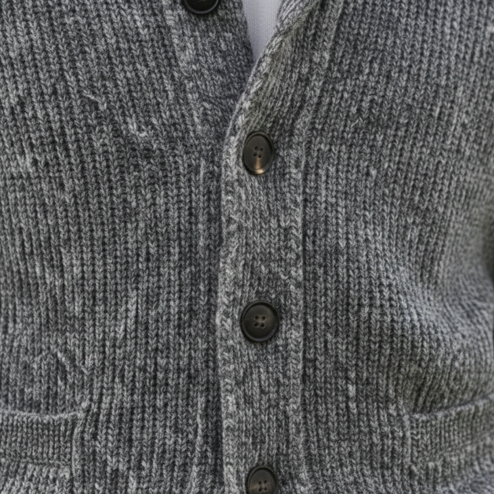 A man wearing a grey shawl-collar cardigan showing a refined and casual style.