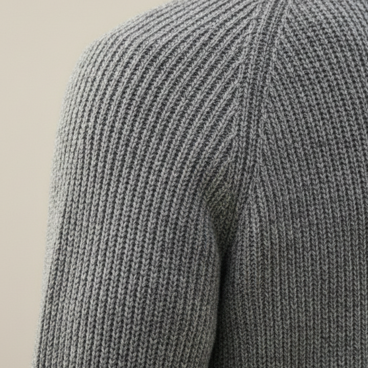 A man wearing a grey shawl-collar cardigan showing a refined and casual style.