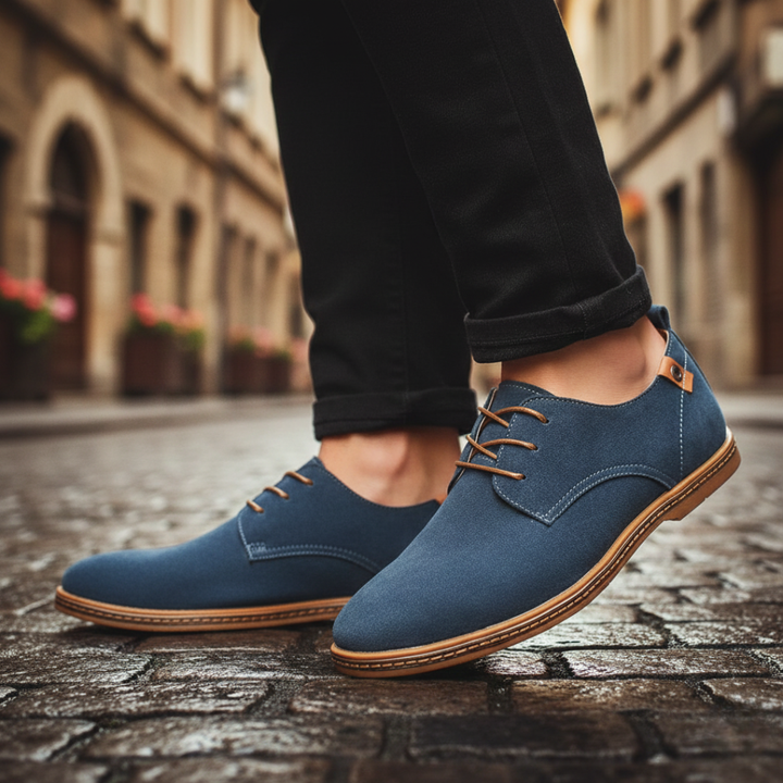 Blue suede derby shoes with a lace-up design, featuring a rounded toe and low rubber heel for smart-casual wear.