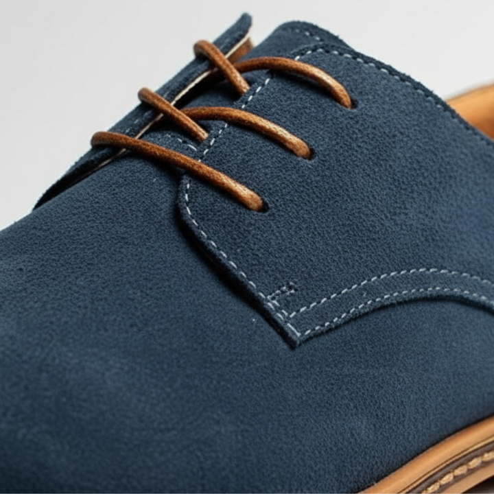 Blue suede derby shoes with a lace-up design, featuring a rounded toe and low rubber heel for smart-casual wear.