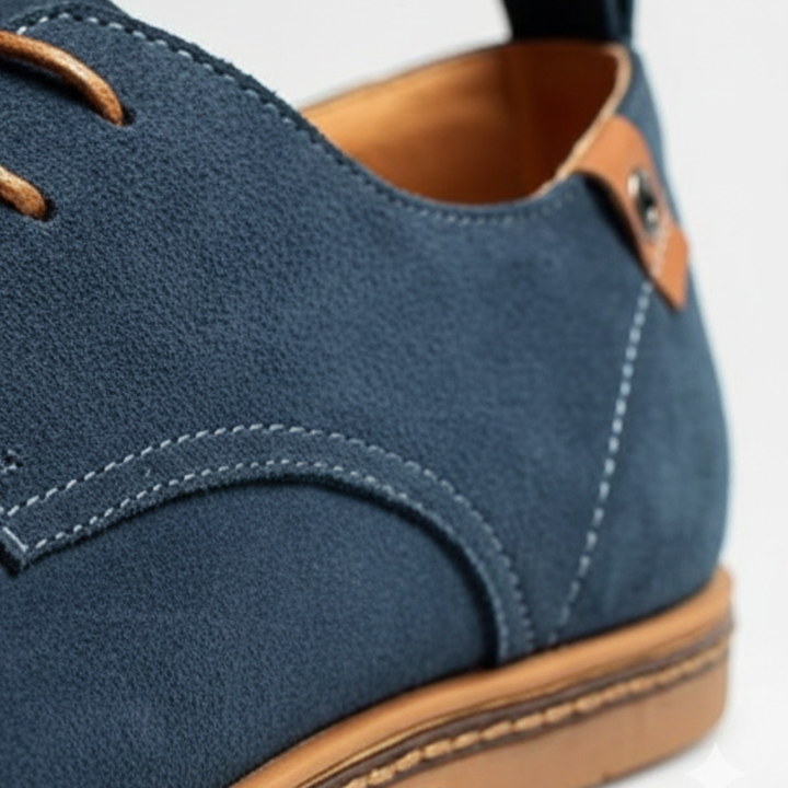 Blue suede derby shoes with a lace-up design, featuring a rounded toe and low rubber heel for smart-casual wear.