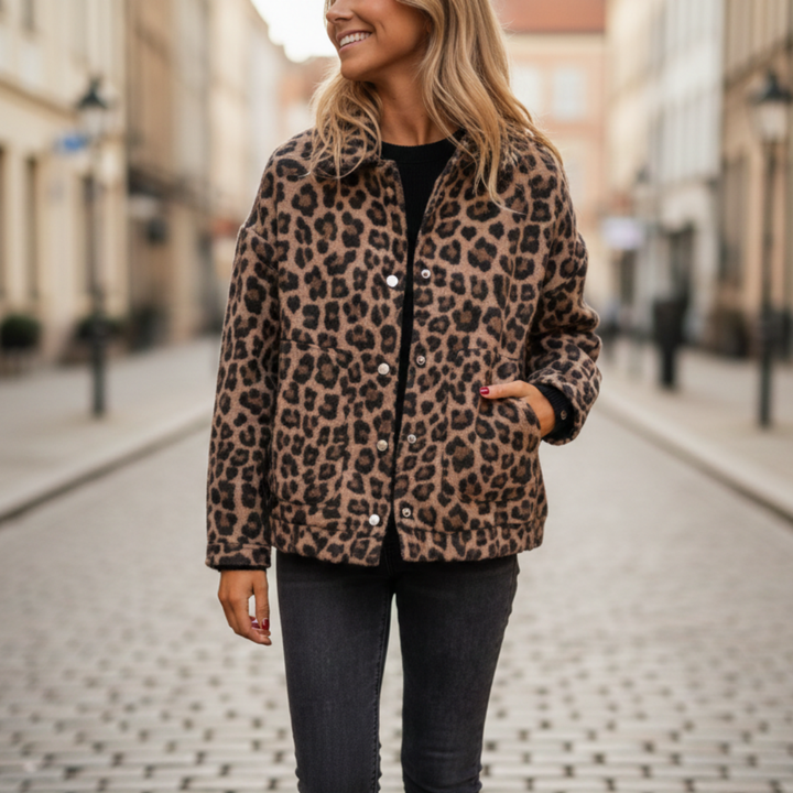 A woman models a leopard print quilted jacket with long sleeves and practical pockets, good for casual layering.
