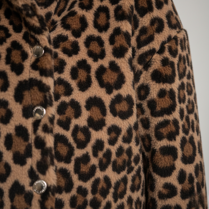 A woman models a leopard print quilted jacket with long sleeves and practical pockets, good for casual layering.
