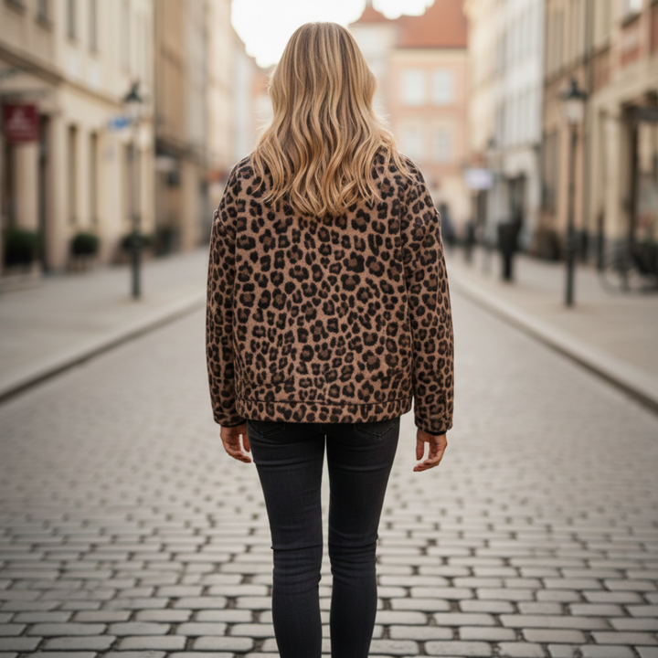 A woman models a leopard print quilted jacket with long sleeves and practical pockets, good for casual layering.
