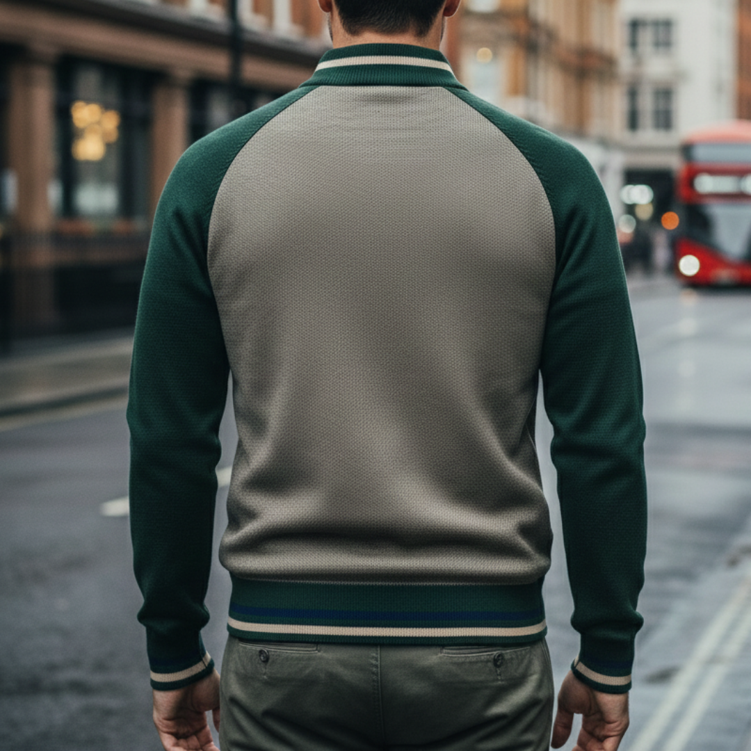 a green zip-front sweater and black pants, showcasing a modern, structured knitwear style for fall and winter.