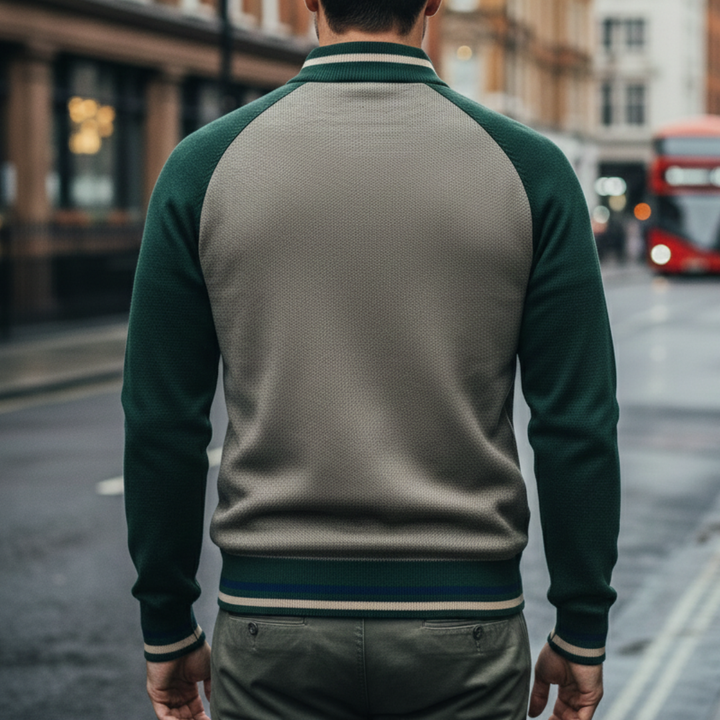 a green zip-front sweater and black pants, showcasing a modern, structured knitwear style for fall and winter.