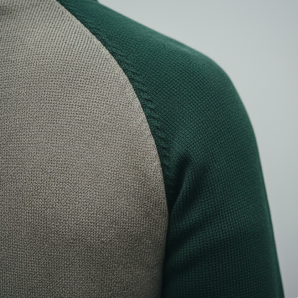 a green zip-front sweater and black pants, showcasing a modern, structured knitwear style for fall and winter.