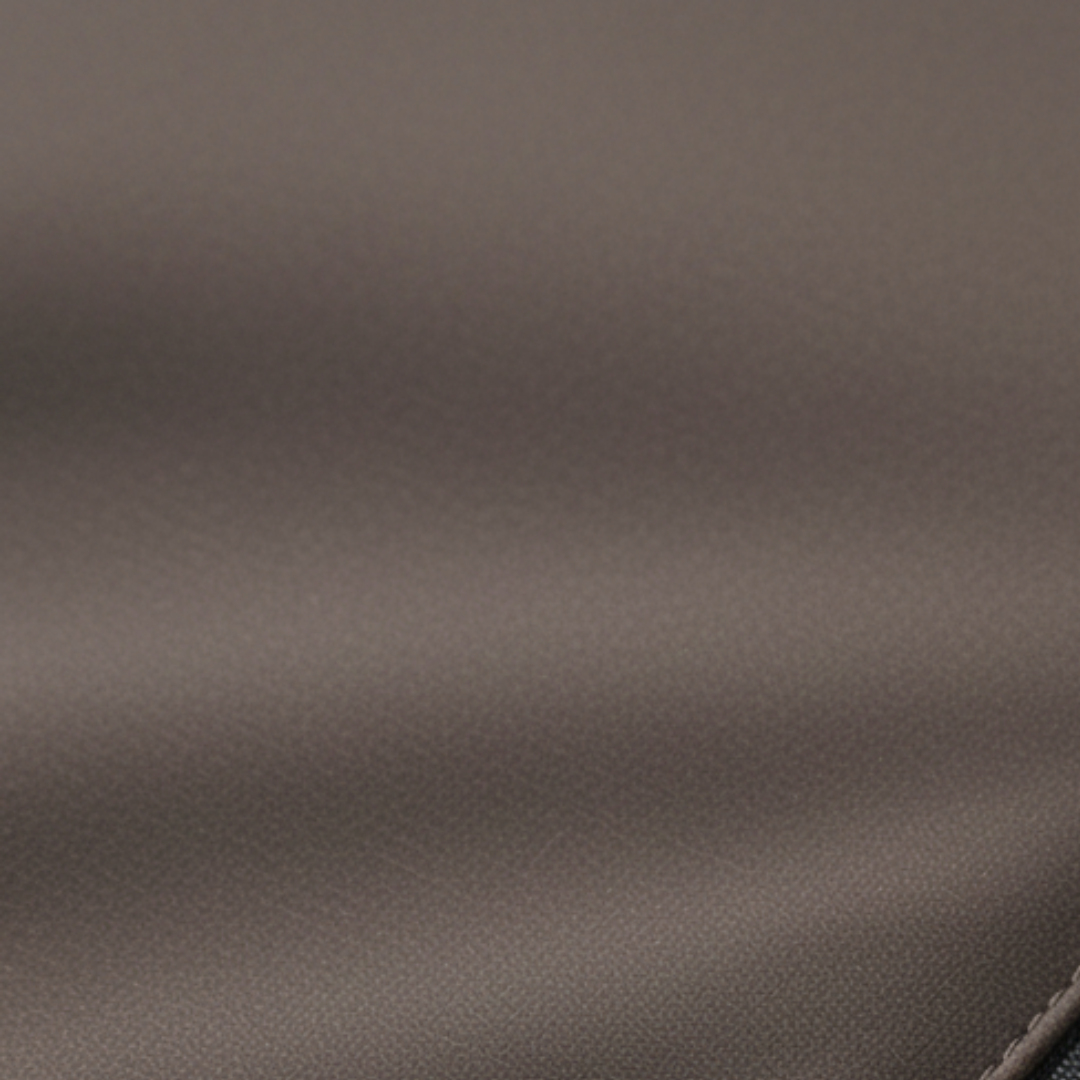 Unisex brown parka, featuring a hood, insulated design, and a streamlined silhouette for winter wear.