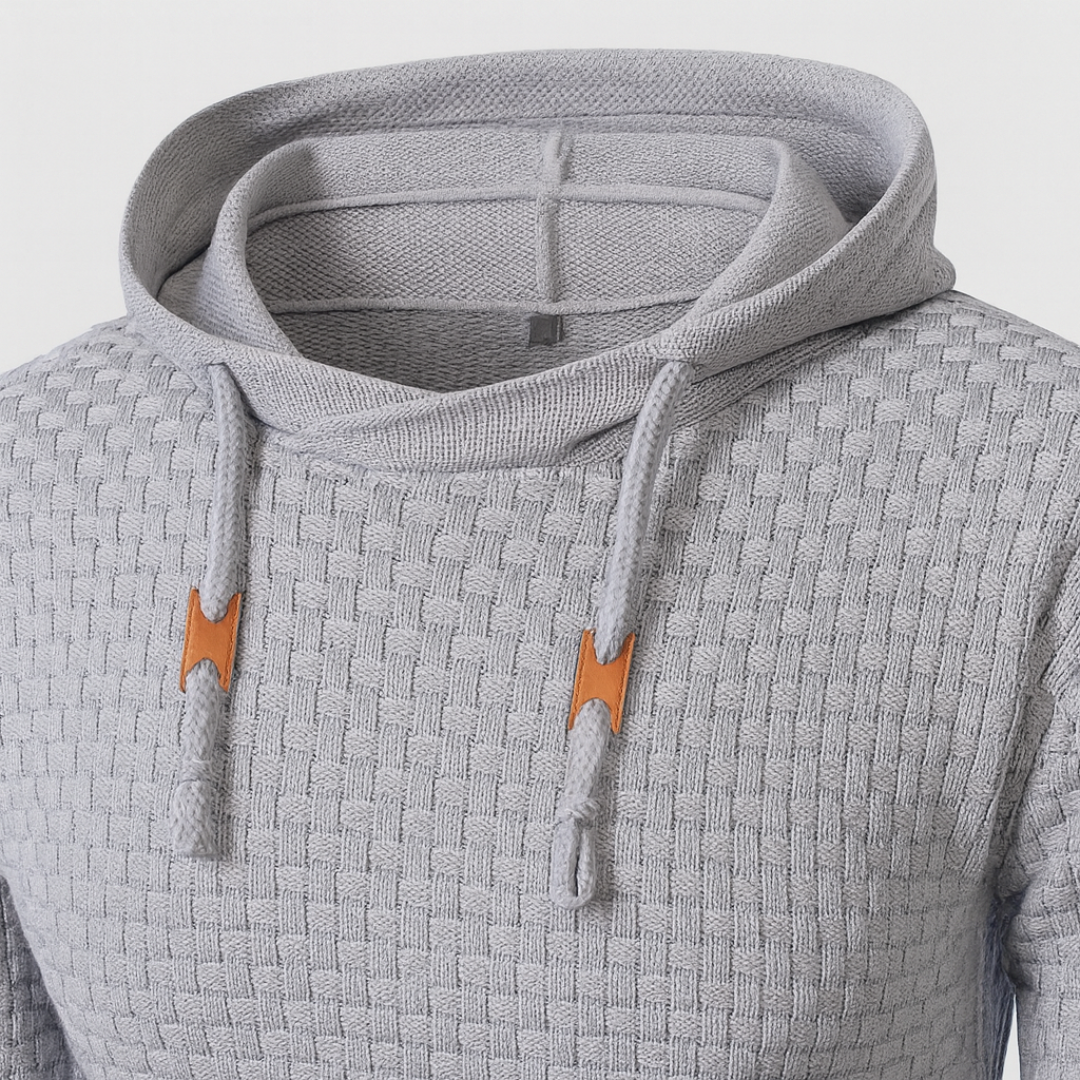  Grey hoodie sweater with a textured knit, featuring a hood, drawstrings, and long sleeves, ideal for fall and winter wear.