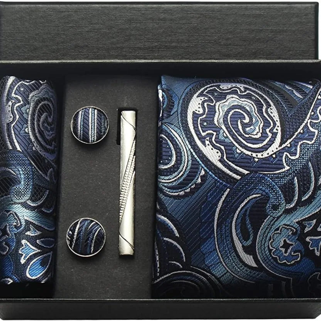 Set of a blue paisley tie, cufflinks, and a pocket square, showcasing classic elegance for formal occasions.