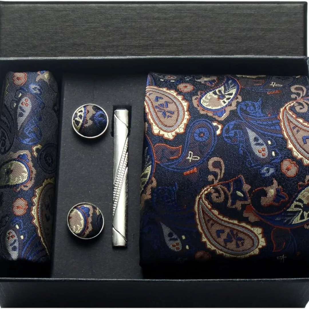 Set of a navy paisley tie, cufflinks, and a pocket square, showcasing classic elegance for formal occasions.