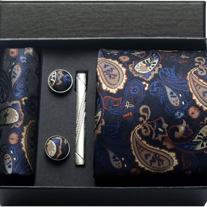 Set of a navy paisley tie, cufflinks, and a pocket square, showcasing classic elegance for formal occasions.