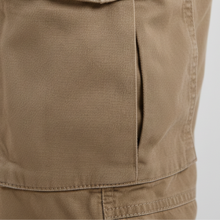  A man wearing khaki cargo pants with multiple pockets, showcasing a modern style for casual wear.