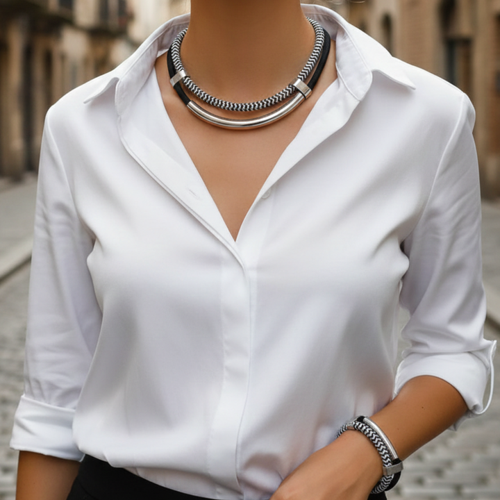 A close-up of a woman's hand adorned with a silver and black bracelet, showcasing modern elegance and style.