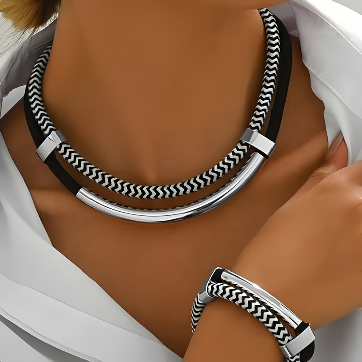 A close-up of a woman's hand adorned with a silver and black bracelet, showcasing modern elegance and style.