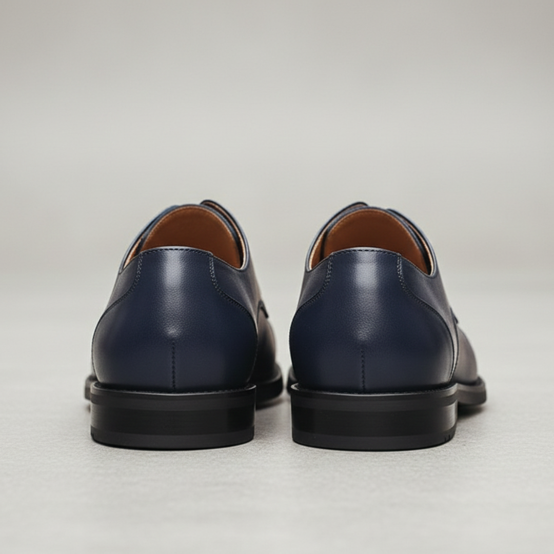 Close up details of a blue leather derby shoes highlighting their classic lace-up style and polished look.