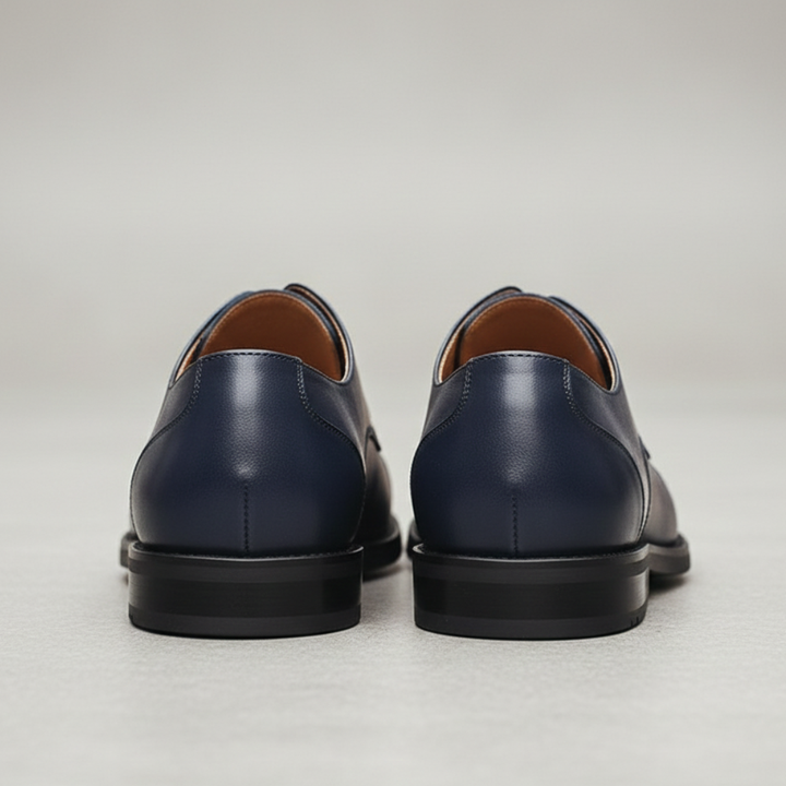 Close up details of a blue leather derby shoes highlighting their classic lace-up style and polished look.