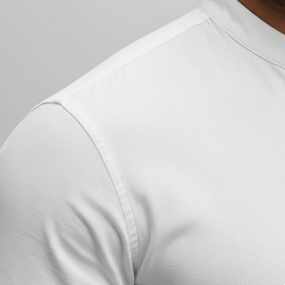 Men's white slim-fit shirt with a mandarin collar and button front, suitable for casual and polished settings.