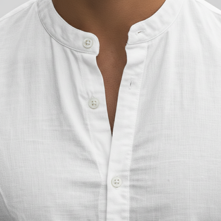 Men's white slim-fit shirt with a mandarin collar and button front, suitable for casual and polished settings.