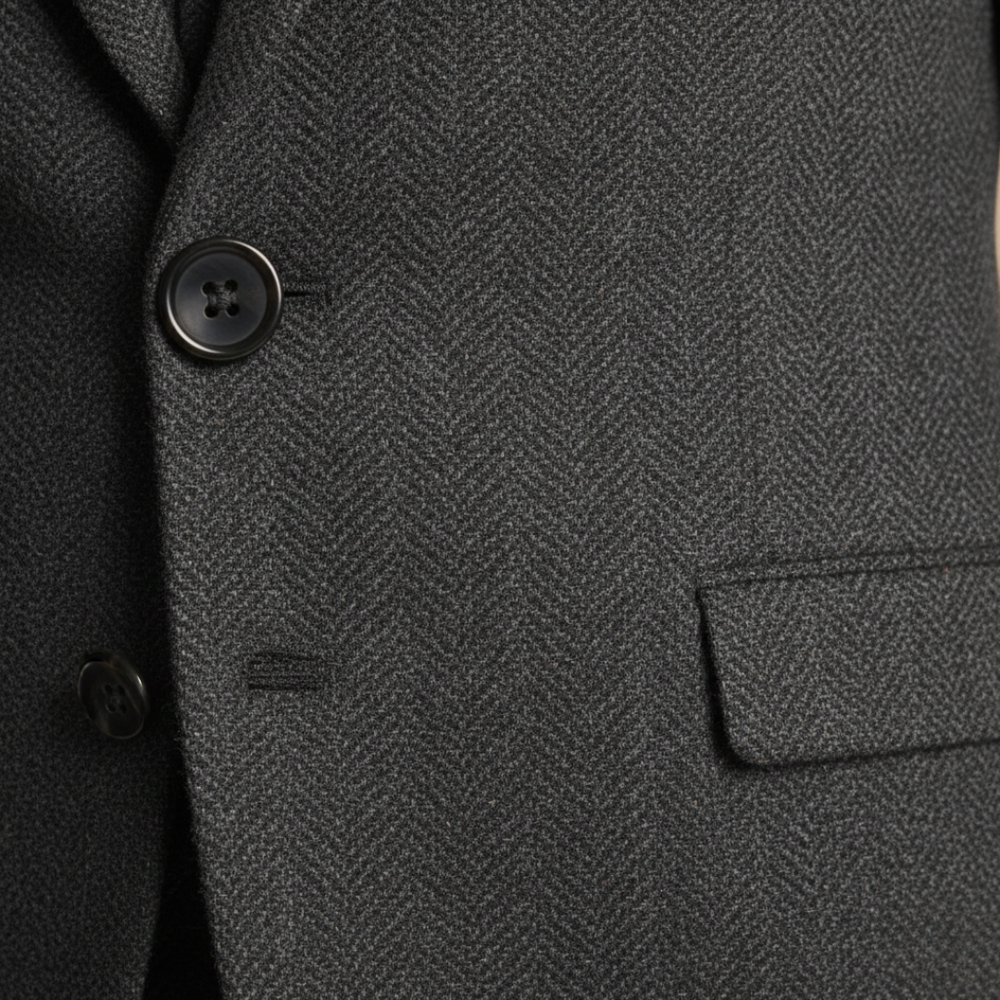 Close-up details of the tailored three-piece suit stands confidently on a cobblestone street, showcasing elegance and style