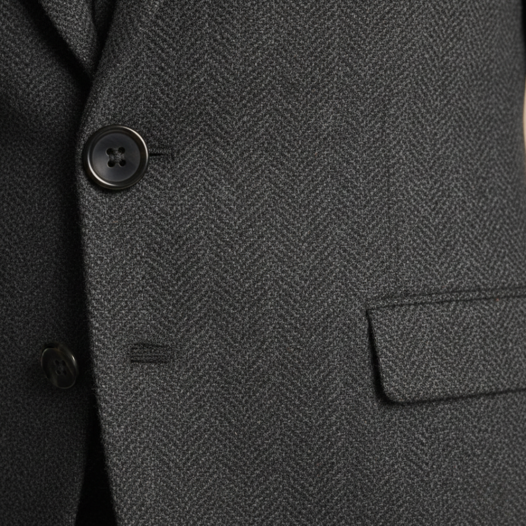 Close-up details of the tailored three-piece suit stands confidently on a cobblestone street, showcasing elegance and style