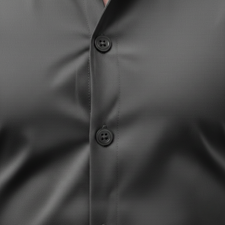 A man wearing a grey button-up shirt and black pants, showcasing a sleek and modern silhouette.