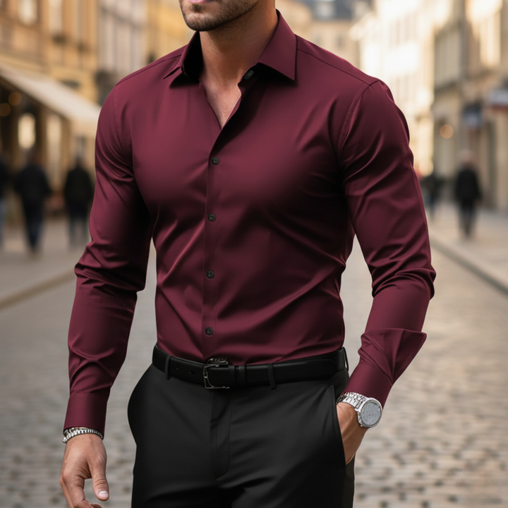 A man wearing a red button-up shirt and black pants, showcasing a sleek and modern silhouette.