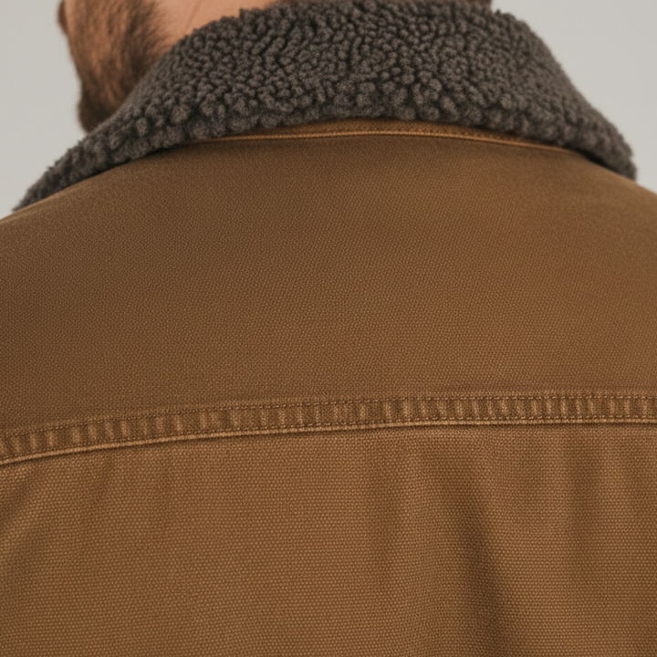 Men's utility jacket with a fur collar, featuring a button front, functional pockets, and a soft sherpa lining for warmth.