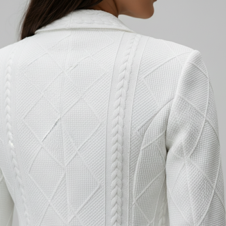 Back details of a woman in a tailored white blazer with cable-knit patterns, shows elegance and versatility.
