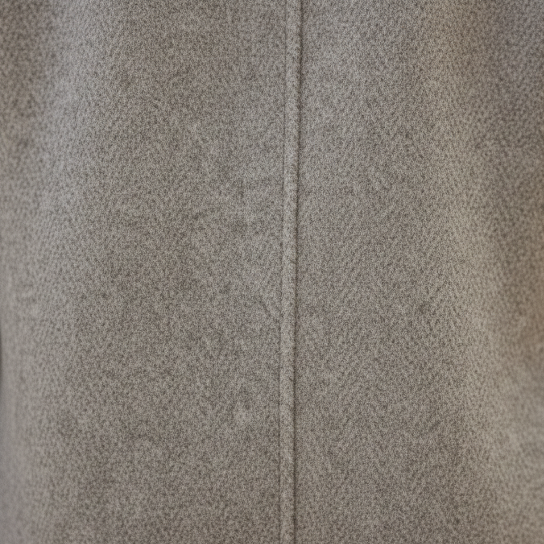 A woman wearing a knee-length double-breasted coat and black pants,  good for fall and winter outings.