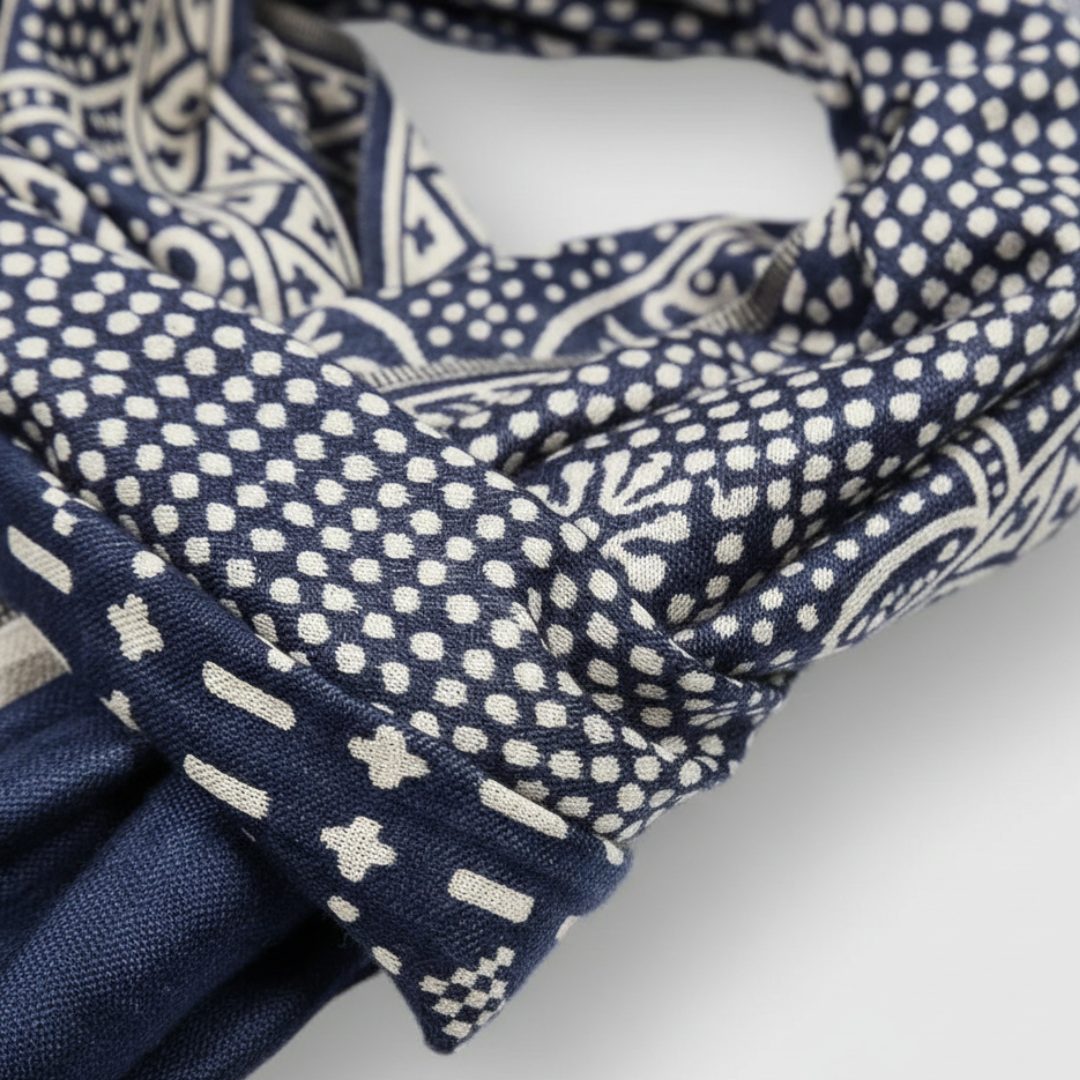 Close-up details of a blue and white geometric patterned scarf, made of 100% cotton, good for casual or polished outfits.
