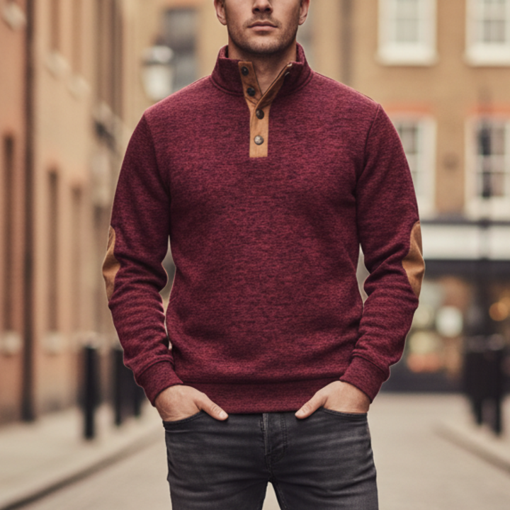 Red sweater with tan elbow patches, high collar, and button details