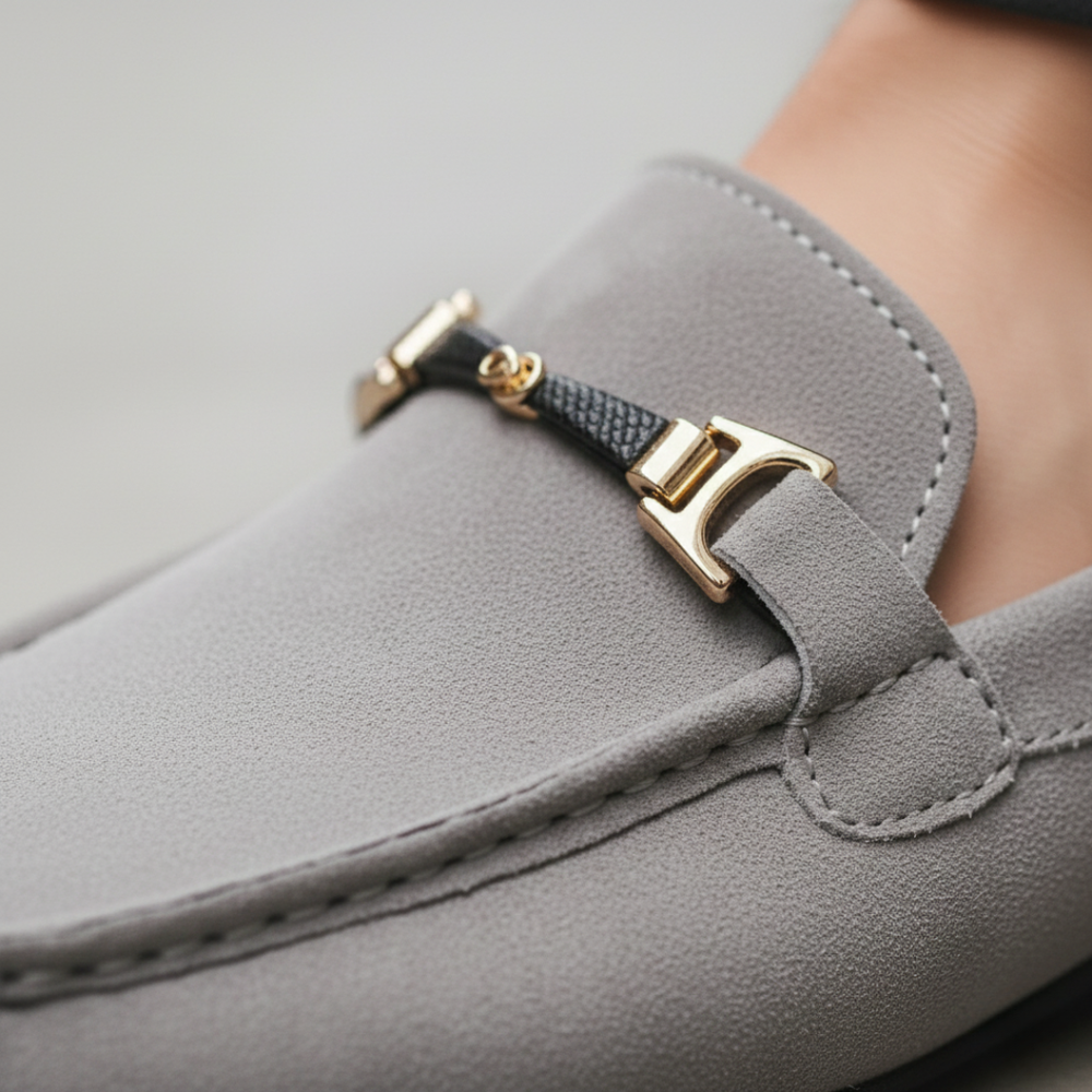 Close-up look grey suede loafers featuring a gold buckle, designed for comfort and style, suitable for casual and semi-formal occasions.