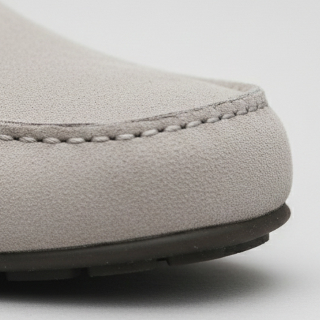 Close-up look grey suede loafers featuring a gold buckle, designed for comfort and style, suitable for casual and semi-formal occasions.