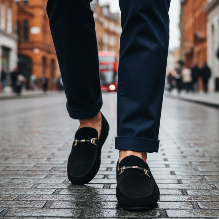 Black suede loafers featuring a gold buckle, designed for comfort and style, suitable for casual and semi-formal occasions.