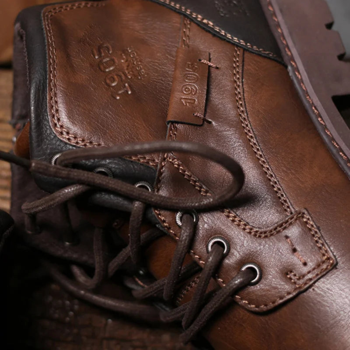 Men's brown leather lace-up boots with a rounded toe, ankle height, and rubber sole, good for casual and elevated styles.