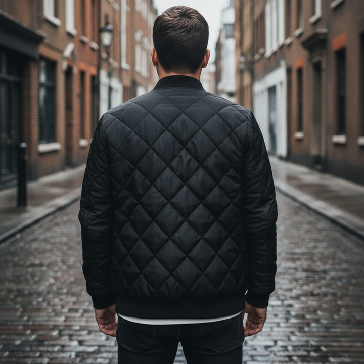 Men's quilted bomber jacket featuring a diamond-stitched finish, zip-front, ribbed neckline in a close-up look. 