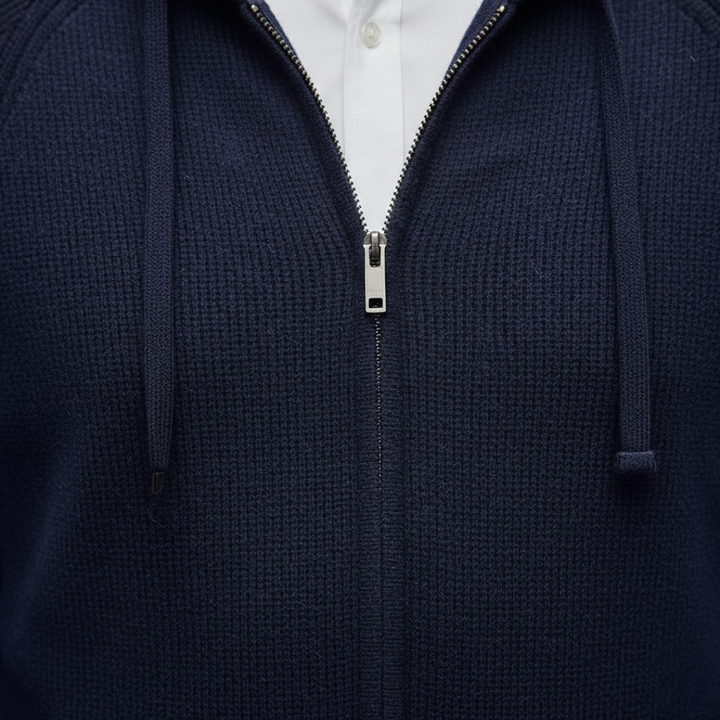 Close-up look of a navy hooded cardigan in ribbed knit, featuring a zip-up front and relaxed fit, ideal for fall and winter layering.