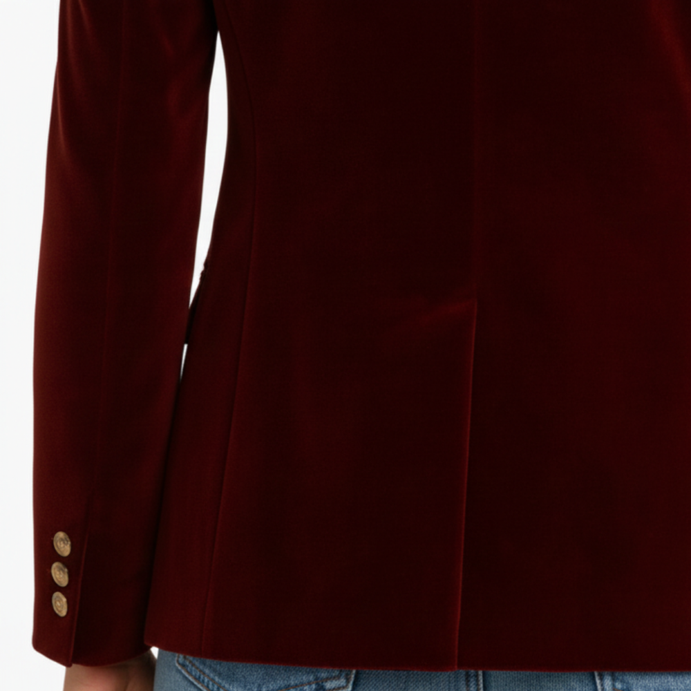 A red velvet blazer with a notched lapel, long sleeves, and a tailored fit, perfect for fall and winter styling.