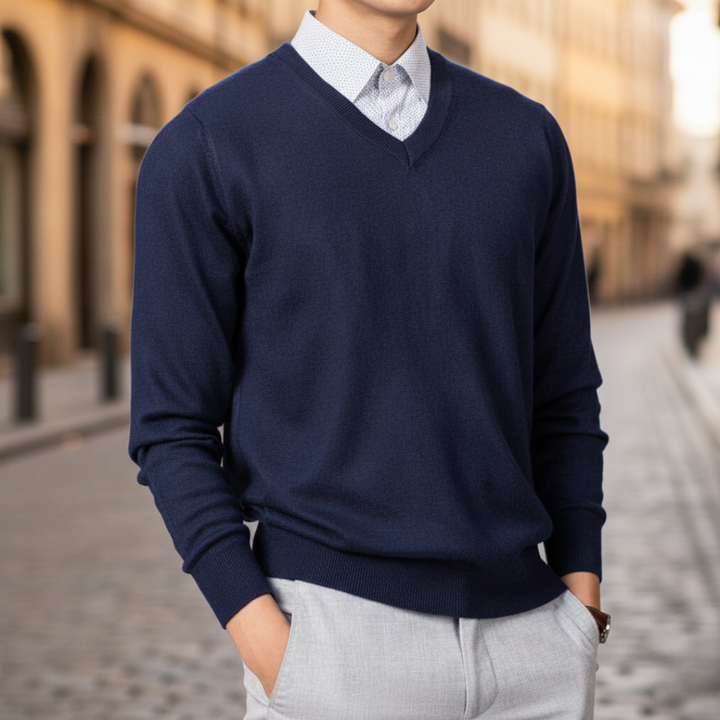 A man dressed in a navy V-neck sweater, highlighting a regular fit and fine knit texture for layering.