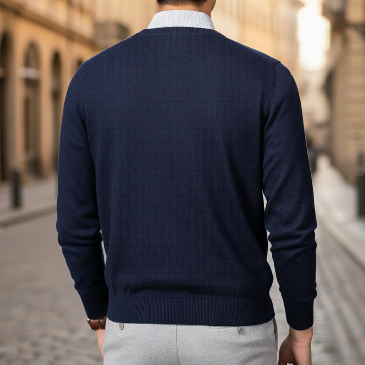 A man dressed in a navy V-neck sweater, highlighting a regular fit and fine knit texture for layering.