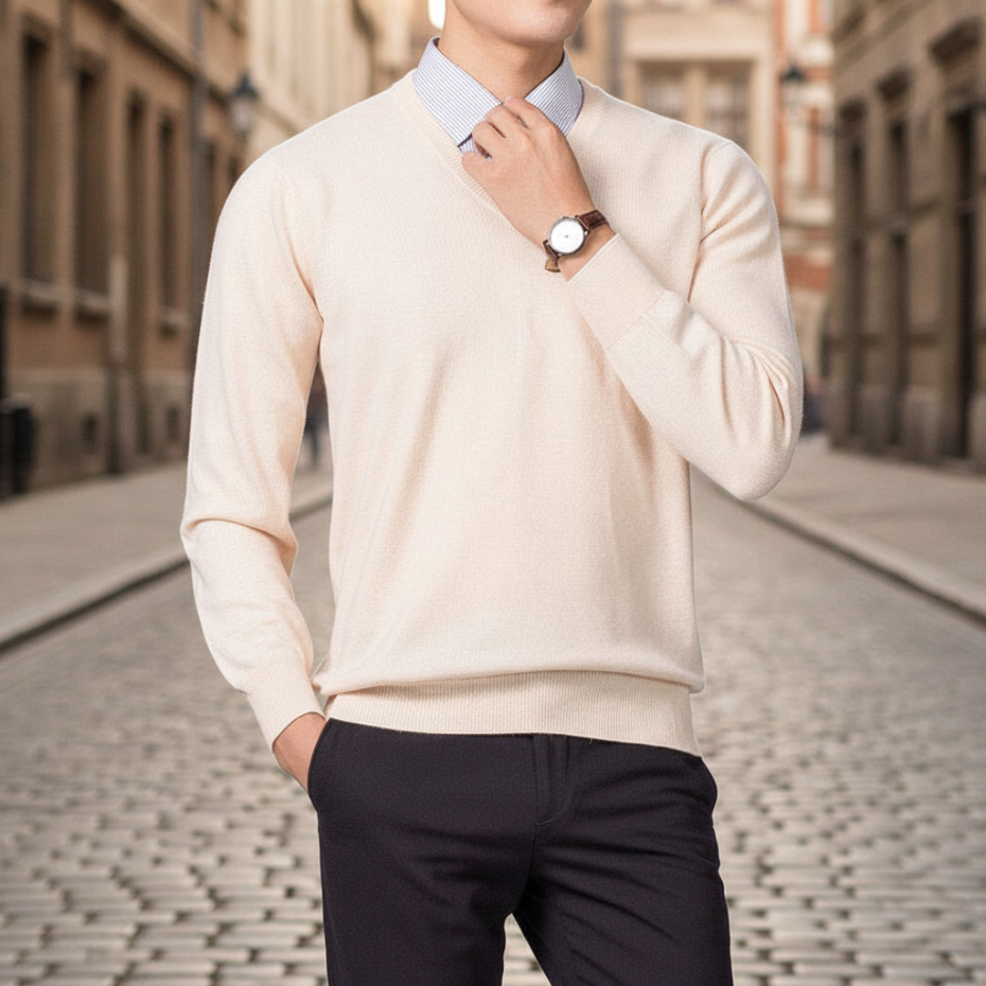 A man dressed in a beige V-neck sweater, highlighting a regular fit and fine knit texture for layering.