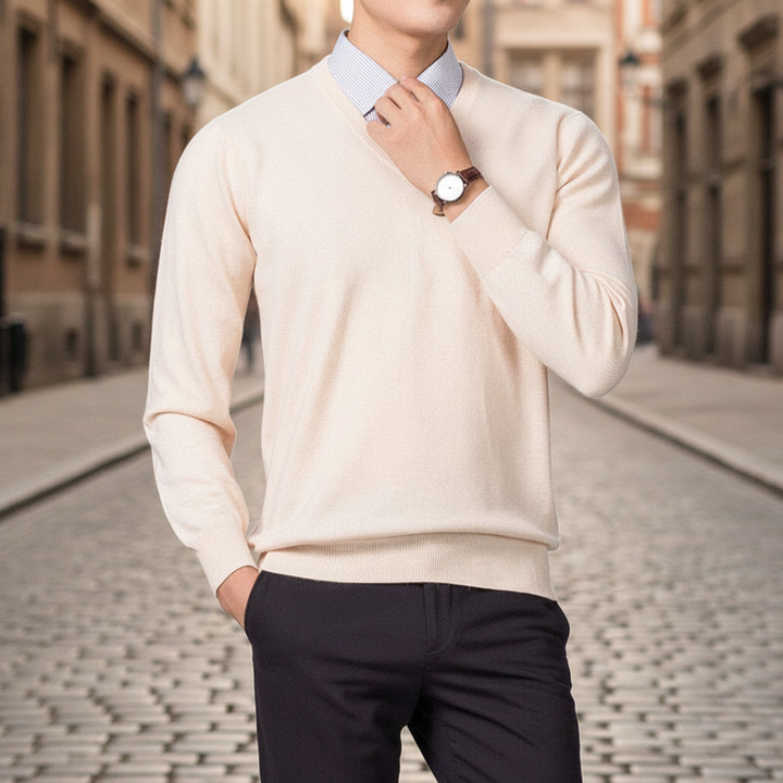 A man dressed in a beige V-neck sweater, highlighting a regular fit and fine knit texture for layering.