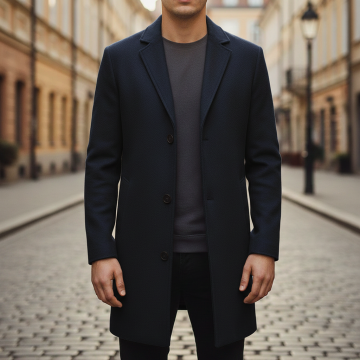 A man in a stylish coat layered over a turtleneck sweater, reflecting a timeless fashion choice.