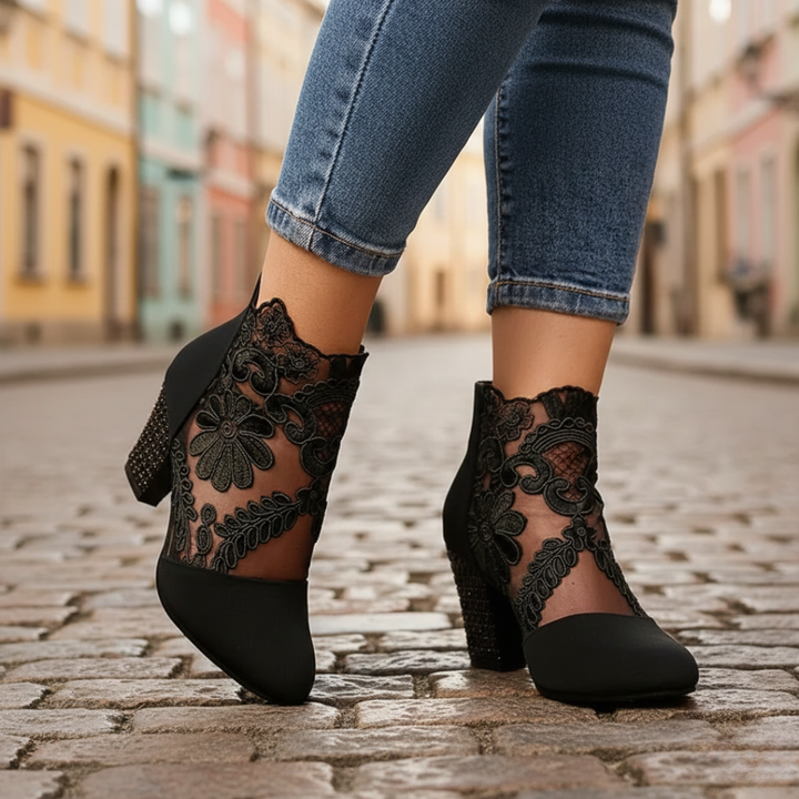 Women's black suede ankle boots with lace detailing, zip closure, and block heel, perfect for fall and spring styling.