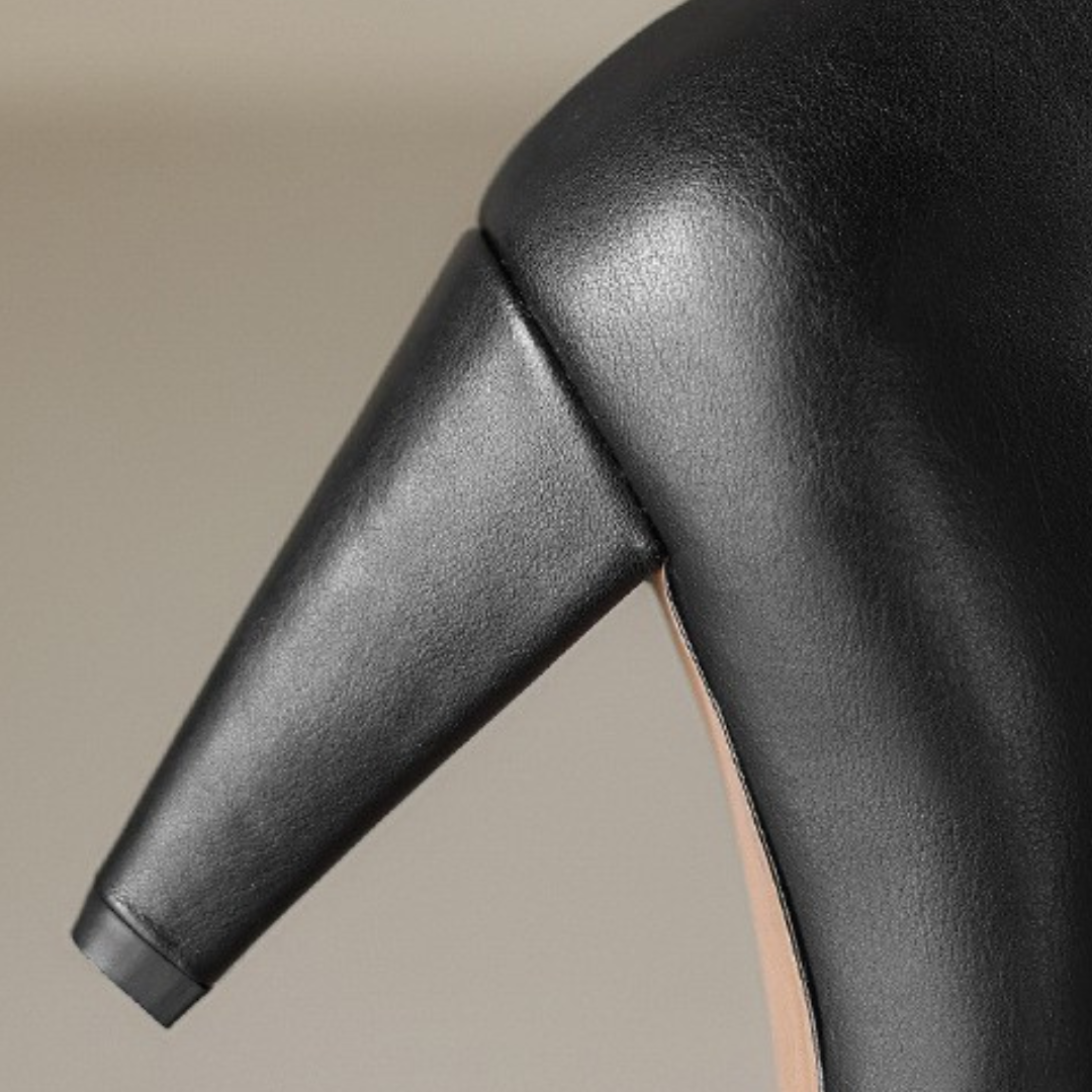 black leather ankle boots and jeans, showcasing a polished and elegant style suitable for various occasions.