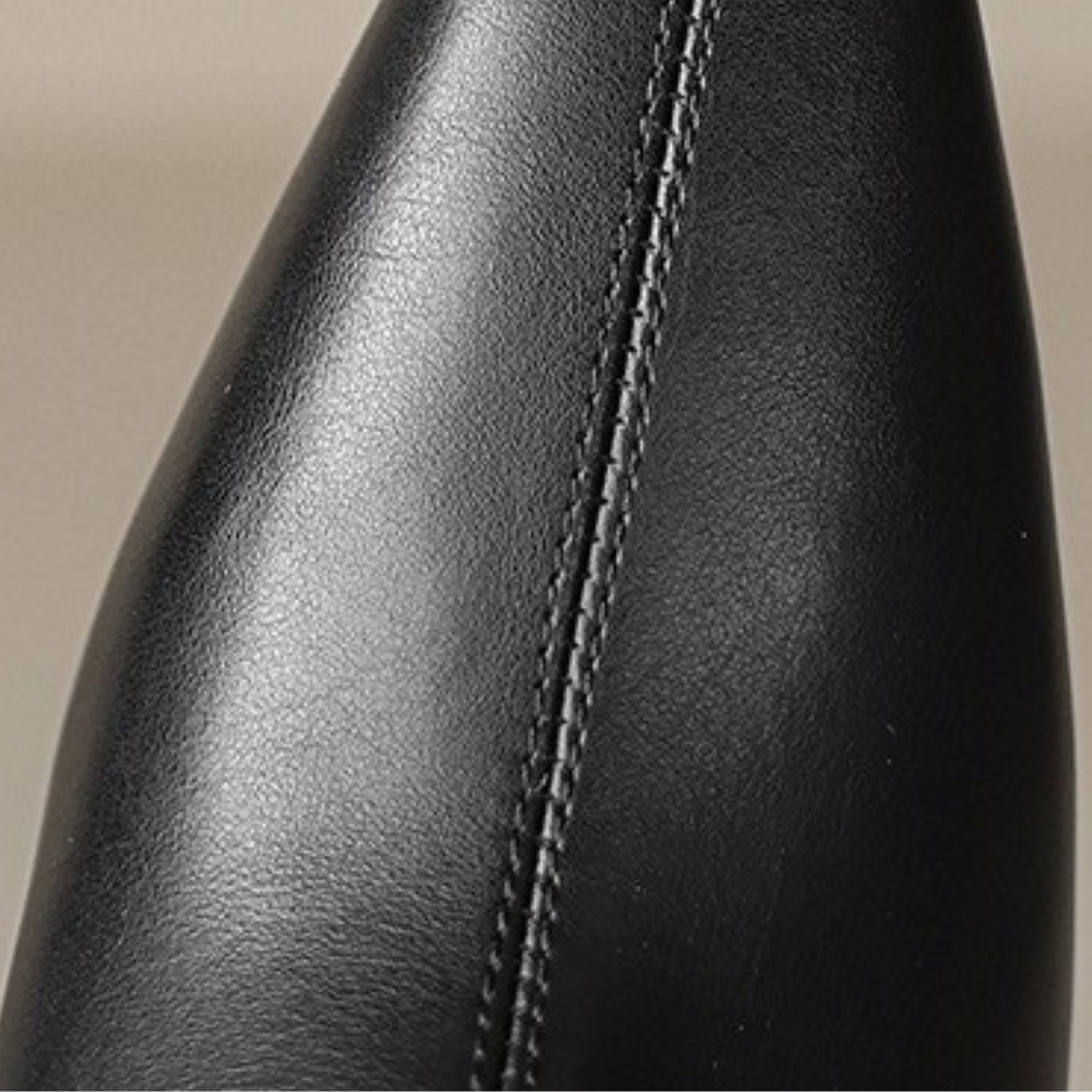 black leather ankle boots and jeans, showcasing a polished and elegant style suitable for various occasions.