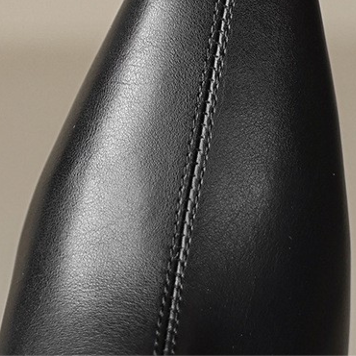 black leather ankle boots and jeans, showcasing a polished and elegant style suitable for various occasions.