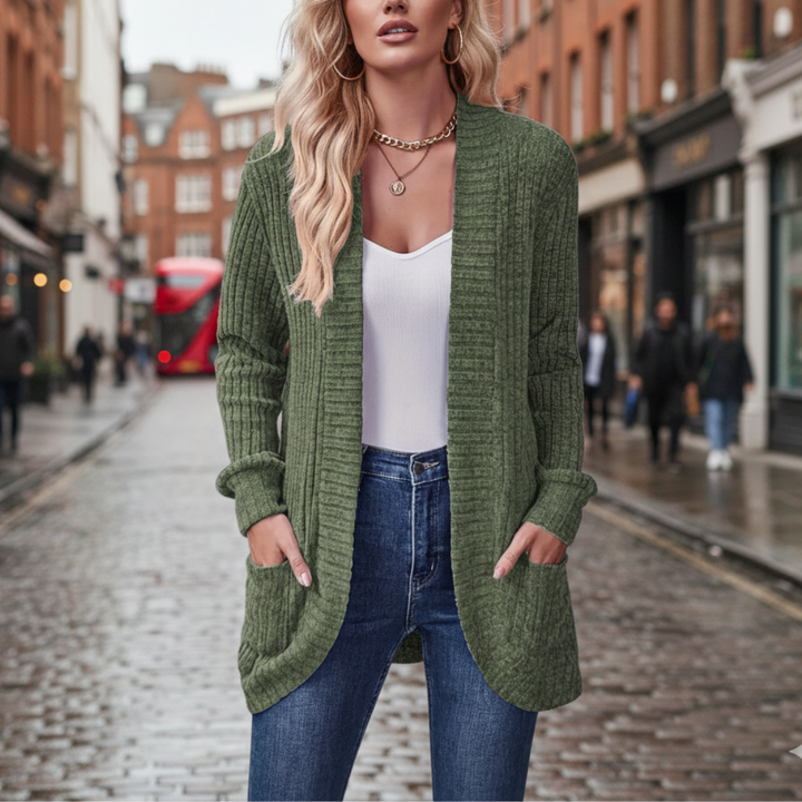  A woman in a green cardigan sweater, showcasing a cozy and stylish look for fall and winter.